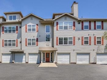 A large apartment building with two garages